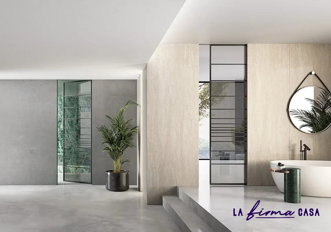 Black framed glass doors in a travertine bathroom by Barausse in Canada
