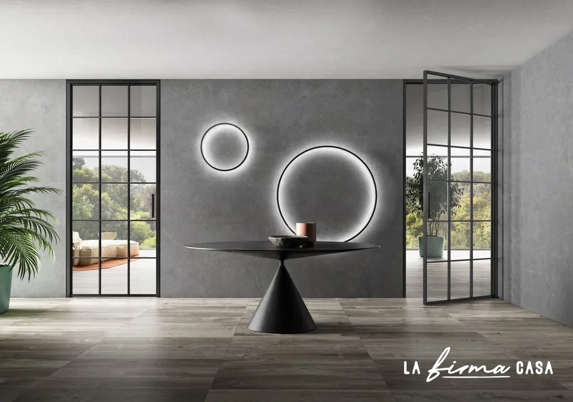 Black grid glazed doors with round wall mirrors by Barausse in Canada