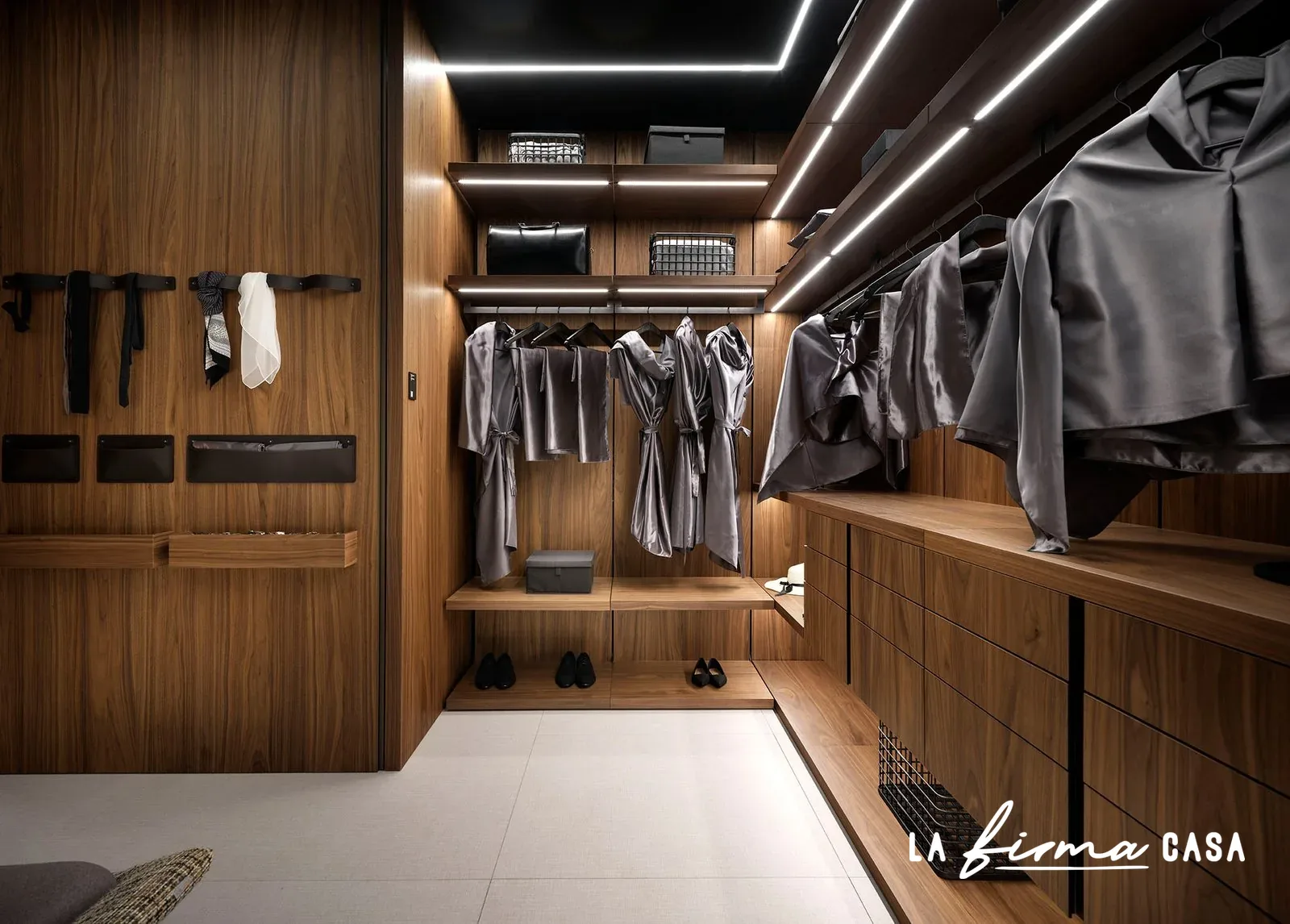 Walnut walk in closet with open shelving by Barausse in Canada