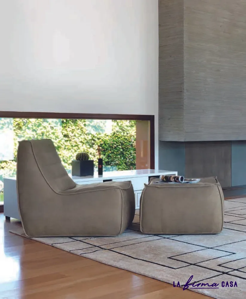 Taupe armchair and pouf by a garden window by Gyform in Canada
