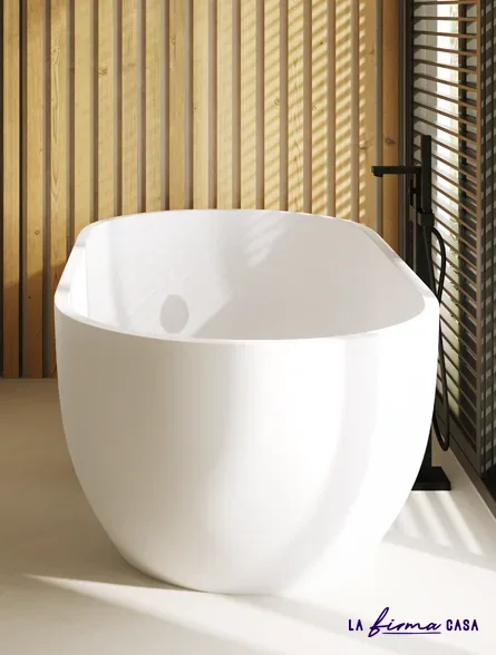 Freestanding bath against slatted wood by IW&W in Canada