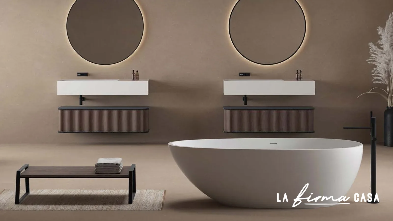 Taupe bathroom with twin round mirrors and oval tub by IW&W in Canada