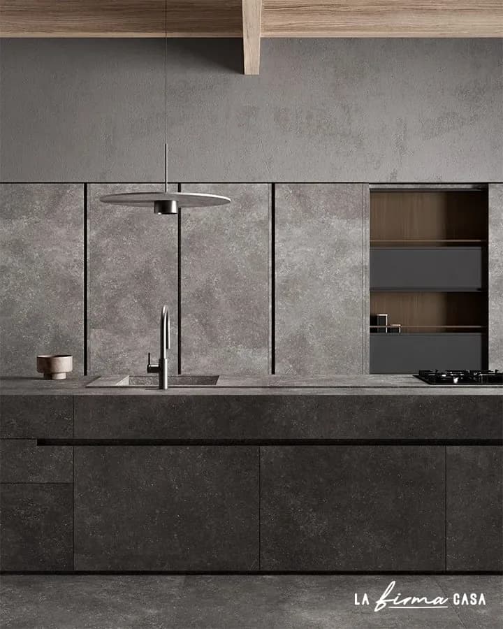 Dark stone kitchen with pendant light by TerzaDimensione in Canada