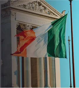 The Italian flag flying outside a neoclassical building