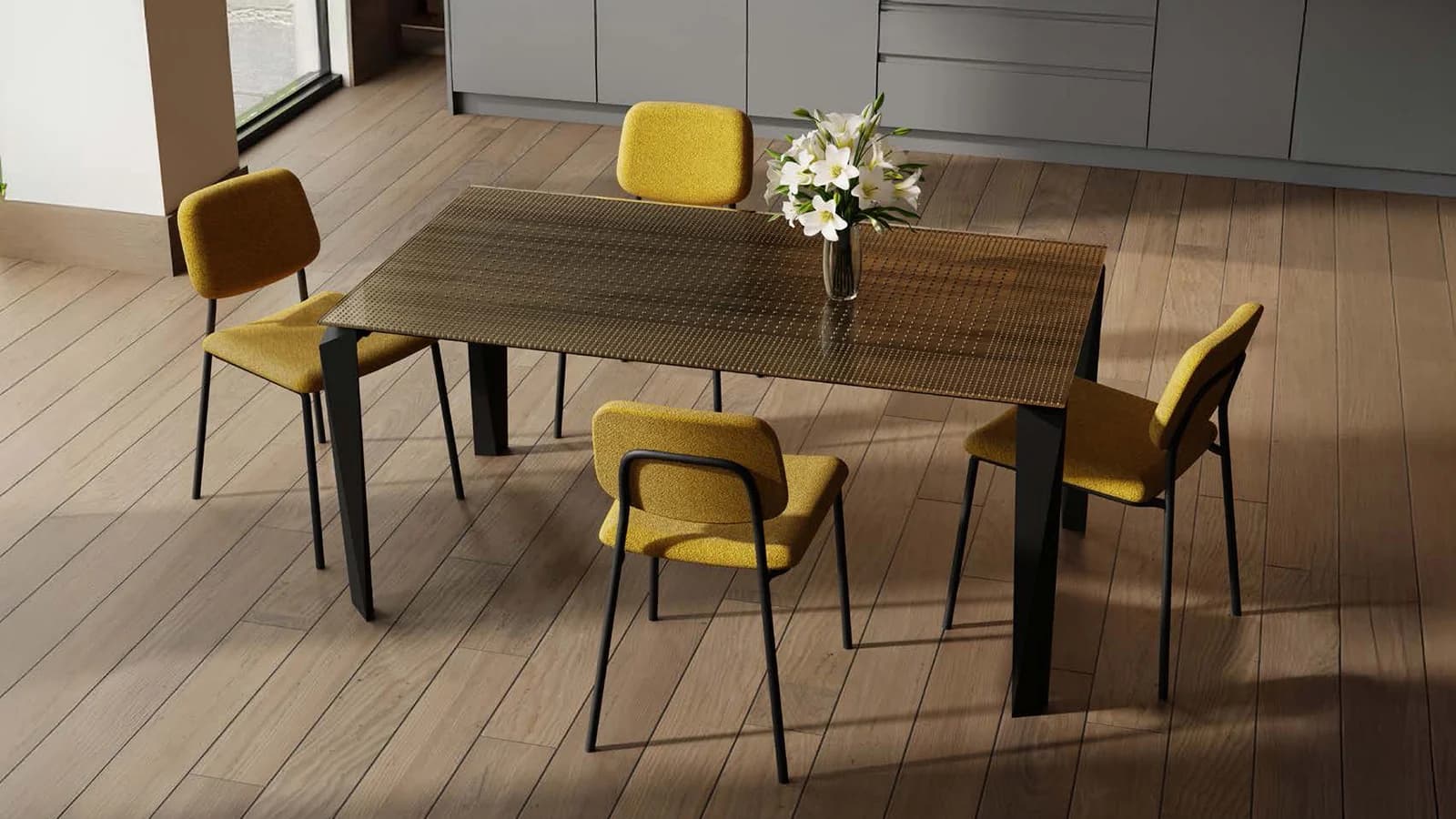 A woven dining table with yellow upholstered chairs and fresh flowers