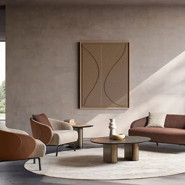 Adorea Design living room with curved terracotta armchairs, a brown sofa and a round bronze coffee table on a circular rug