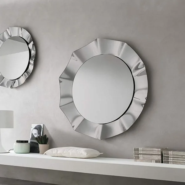Target Point pair of round wall mirrors with sculpted rippled glass frames above a white floating shelf on a grey plaster wall